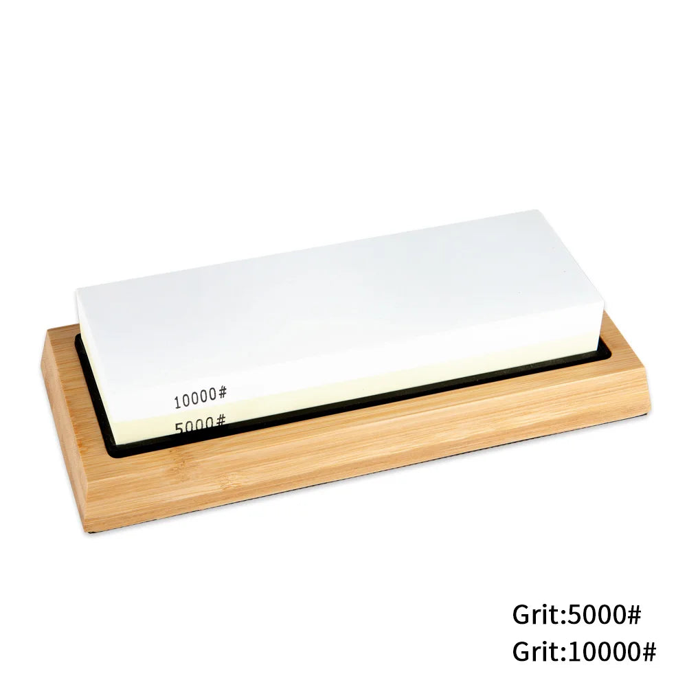 Whetstone with different grits on a wooden base against a white background