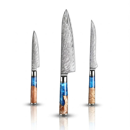 Set of three knives with Damascus steel blades and colorful handles on a white background