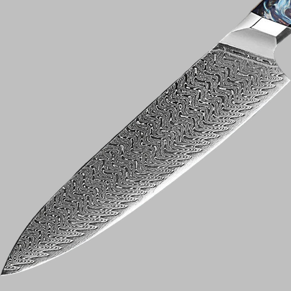 Close-up of a knife blade with intricate patterns on a gray background