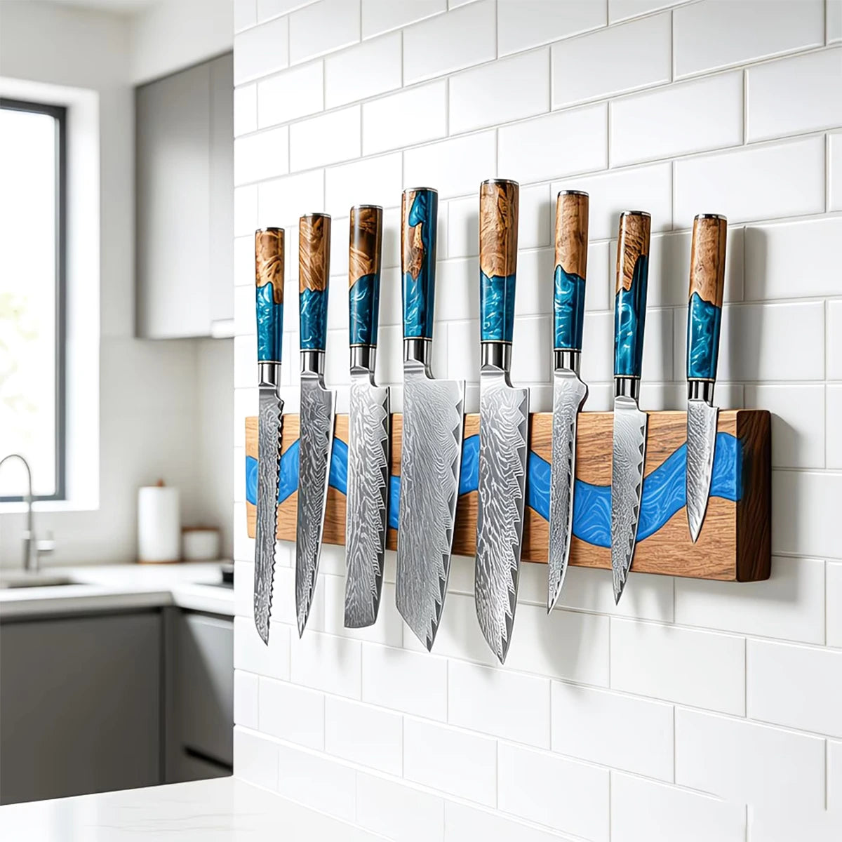 Acacia wood magnetic knife holder with blue resin river mounted in a modern kitchen holding premium kitchen knives